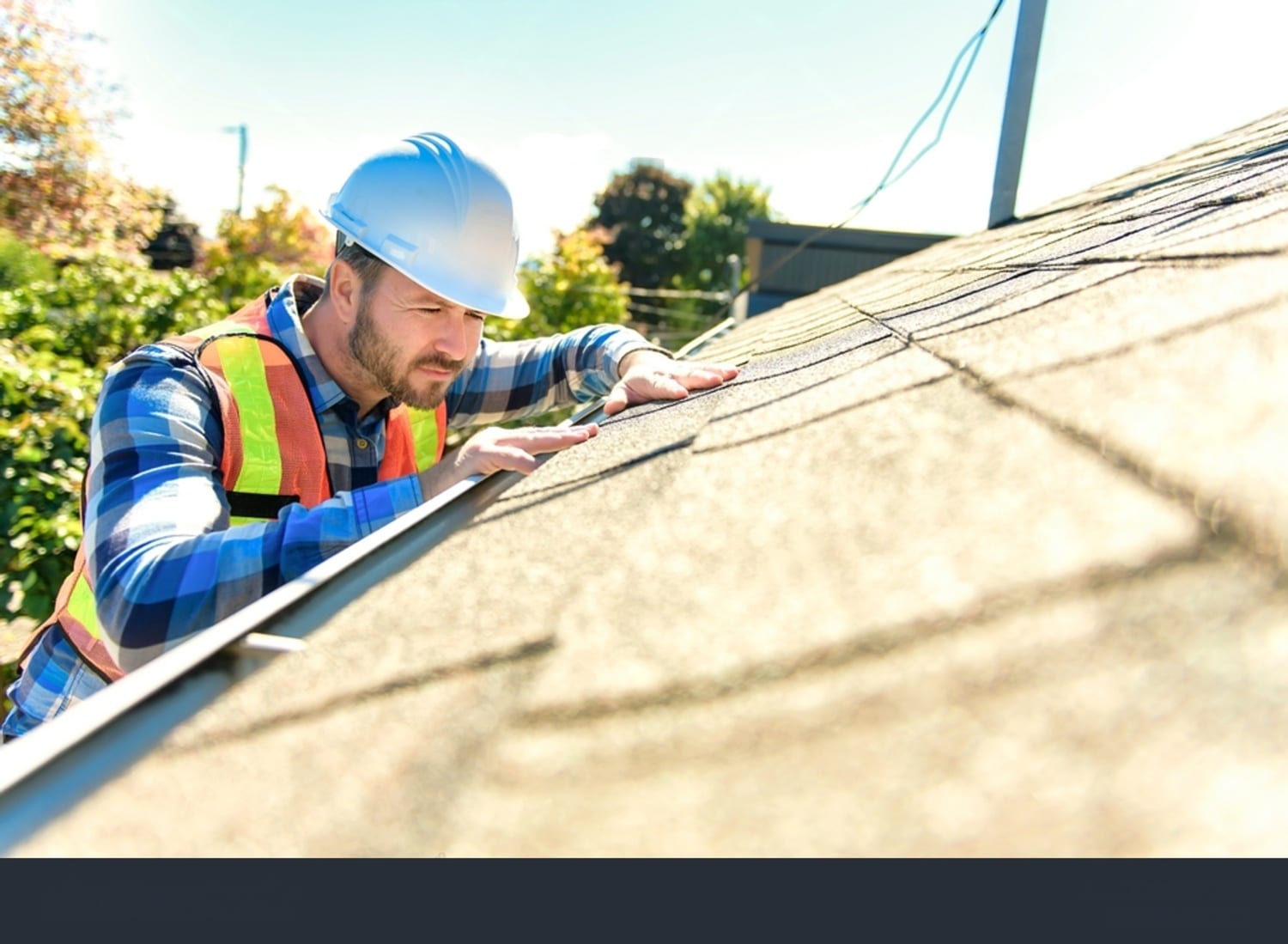 Man inspecting a roof with tools.